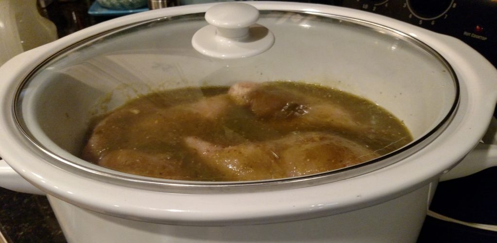 Covered Slow Cooker With Uncooked Verde Chicken