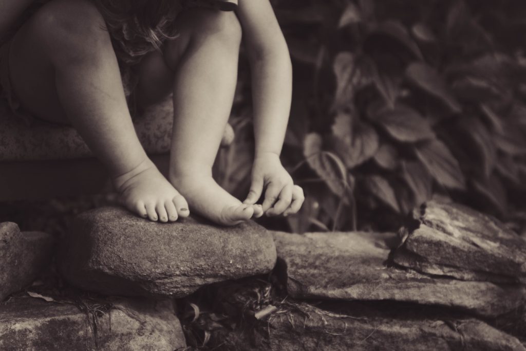 child's feet playing outdoors